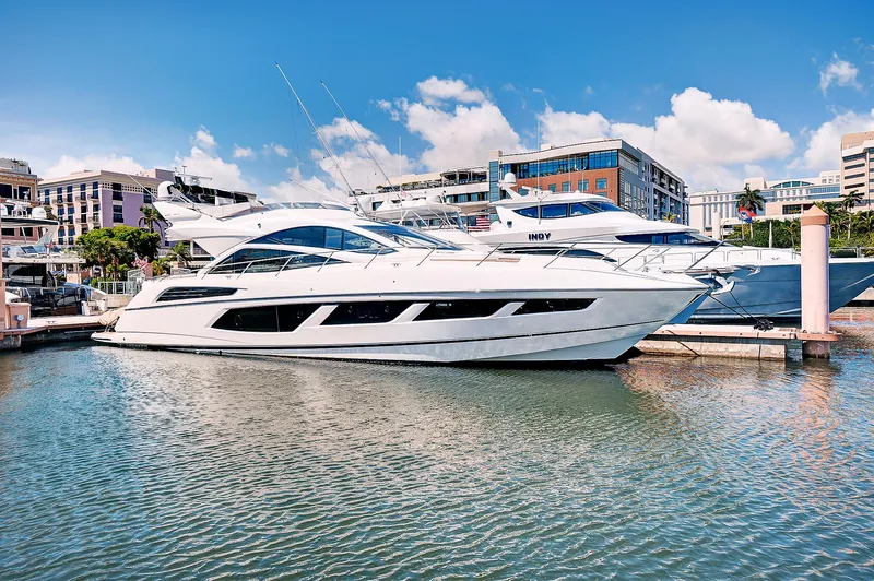 Once Around Yacht Photos Pics 2017 Sunseeker 68 Sport Yacht docked in a marina on a sunny day.