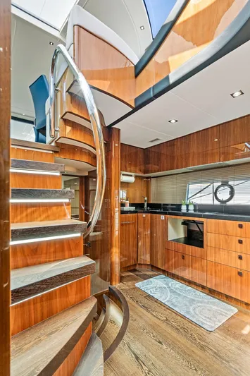 Once Around Yacht Photos Pics 2017 Sunseeker 68 Sport Yacht interior with modern kitchen and spiral staircase.