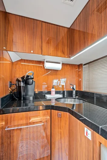 Once Around Yacht Photos Pics 2017 Sunseeker 68 Sport Yacht kitchen with wood cabinetry and modern appliances.