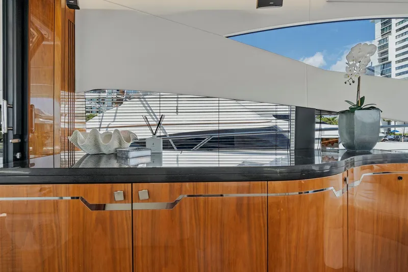 Once Around Yacht Photos Pics Interior of 2017 Sunseeker 68 Sport Yacht with polished wood cabinetry and modern decor.