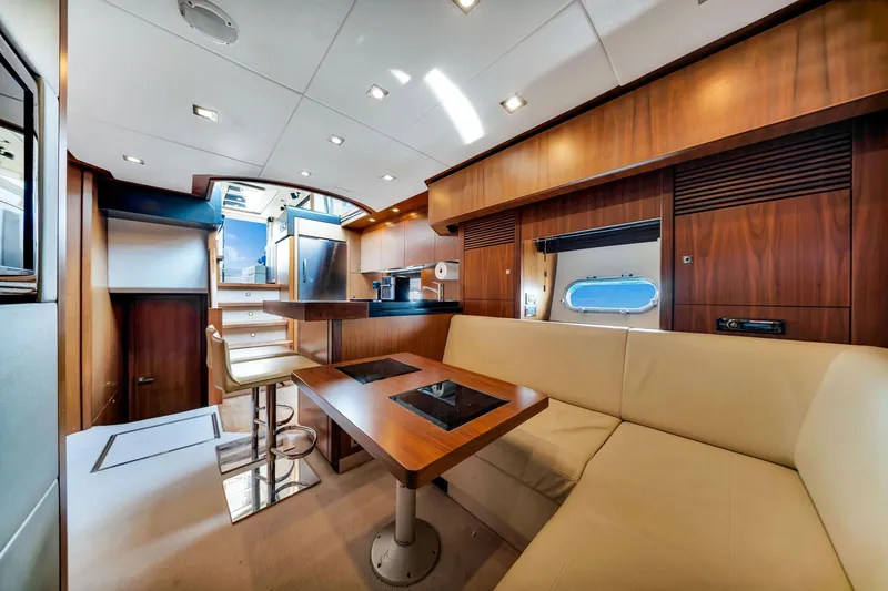 Jimbo Yacht Photos Pics Luxurious interior of 2012 Sunseeker 74 Sport Yacht with modern kitchen and seating area.