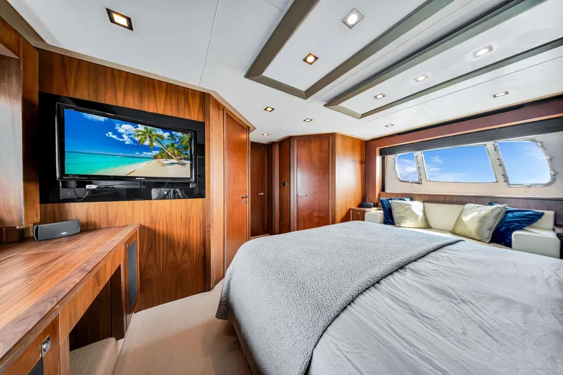Jimbo Yacht Photos Pics Luxurious Sunseeker 74 Sport Yacht 2012 bedroom with wood paneling and ocean view.
