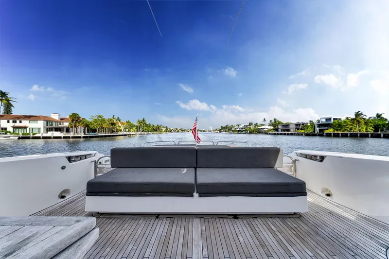 Jimbo Yacht Photos Pics Sunseeker 74 Sport Yacht 2012 on serene waterway, featuring spacious deck and luxurious seating.