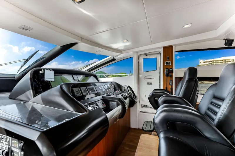 Jimbo Yacht Photos Pics Interior cockpit of 2012 Sunseeker 74 Sport Yacht with modern controls and leather seating.