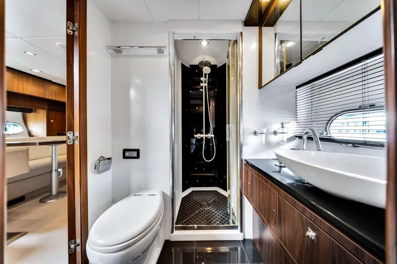 Jimbo Yacht Photos Pics Luxurious bathroom in 2012 Sunseeker 74 Sport Yacht with modern fixtures and elegant design.