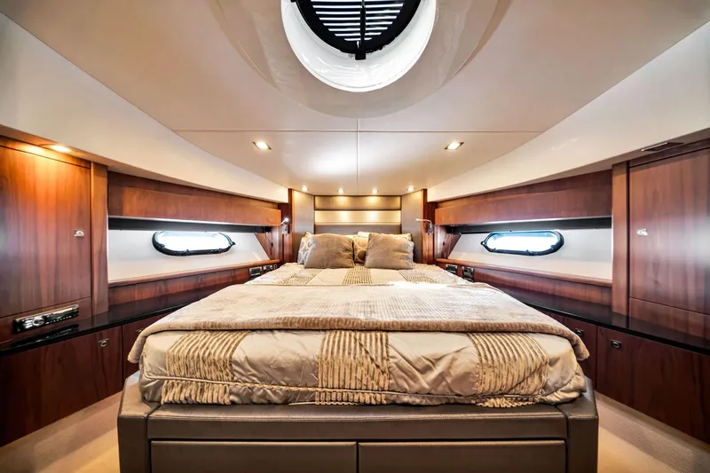 Jimbo Yacht Photos Pics Luxurious bedroom interior of 2012 Sunseeker 74 Sport Yacht with elegant wood finishes.