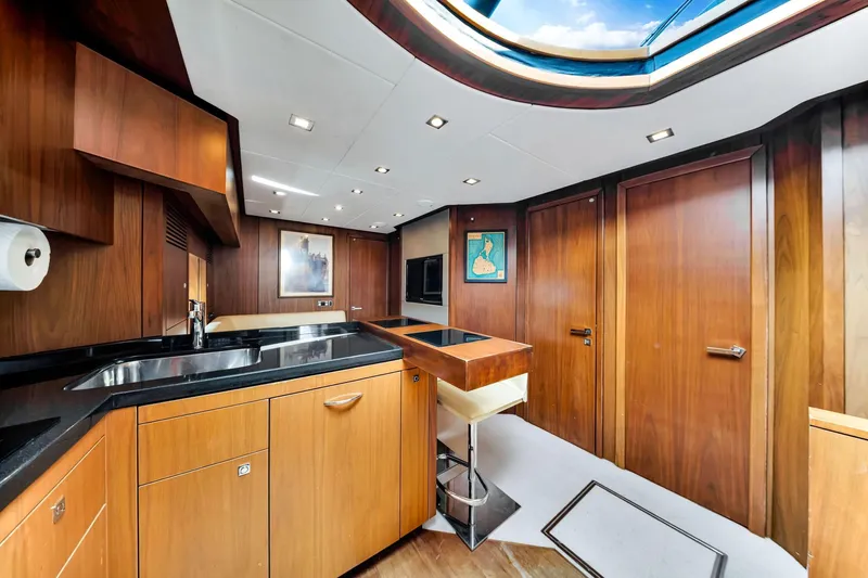Jimbo Yacht Photos Pics Luxurious interior of 2012 Sunseeker 74 Sport Yacht with modern wood finishes and skylight.
