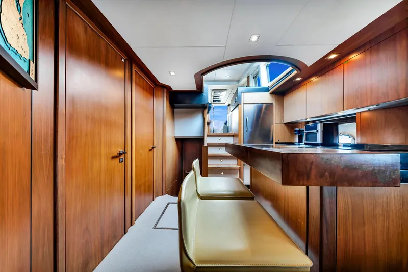 Jimbo Yacht Photos Pics Luxurious interior of 2012 Sunseeker 74 Sport Yacht with wooden finishes and modern amenities.