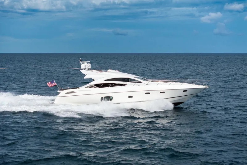 Jimbo Yacht Photos Pics 2012 Sunseeker 74 Sport Yacht cruising on open sea under blue sky.