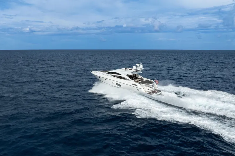 Jimbo Yacht Photos Pics Sunseeker 74 Sport Yacht 2012 cruising on open sea under clear blue sky.