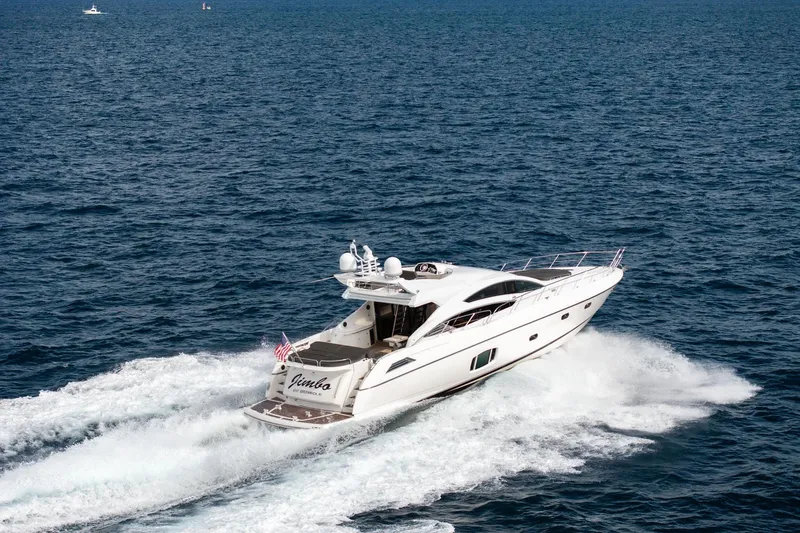 Jimbo Yacht Photos Pics Sunseeker 74 Sport Yacht 2012 cruising on open sea, creating waves.