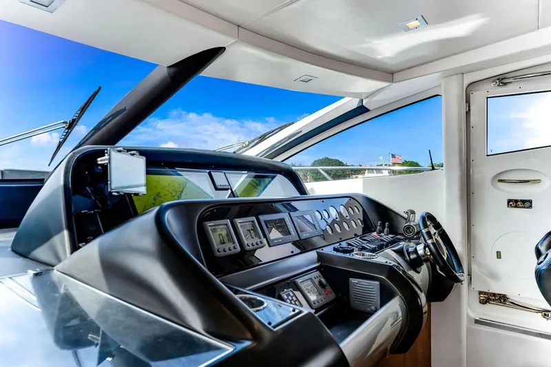 Jimbo Yacht Photos Pics Cockpit of 2012 Sunseeker 74 Sport Yacht with modern navigation equipment and sleek design.