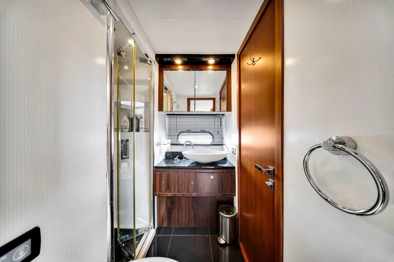 Jimbo Yacht Photos Pics Luxurious bathroom in 2012 Sunseeker 74 Sport Yacht with modern fixtures and elegant design.