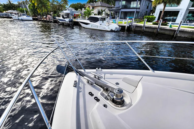 Jimbo Yacht Photos Pics Bow view of 2012 Sunseeker 74 Sport Yacht docked by waterfront homes.