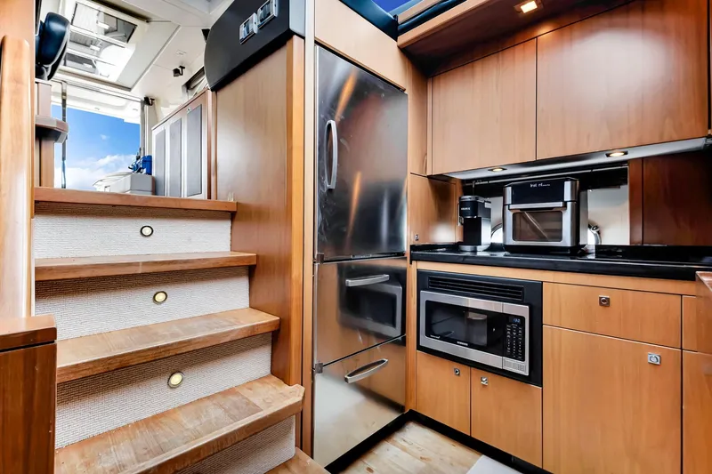 Jimbo Yacht Photos Pics Luxurious kitchen interior of 2012 Sunseeker 74 Sport Yacht with modern appliances.