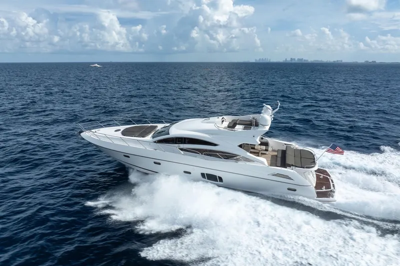 Jimbo Yacht Photos Pics 2012 Sunseeker 74 Sport Yacht cruising on open ocean under clear skies.