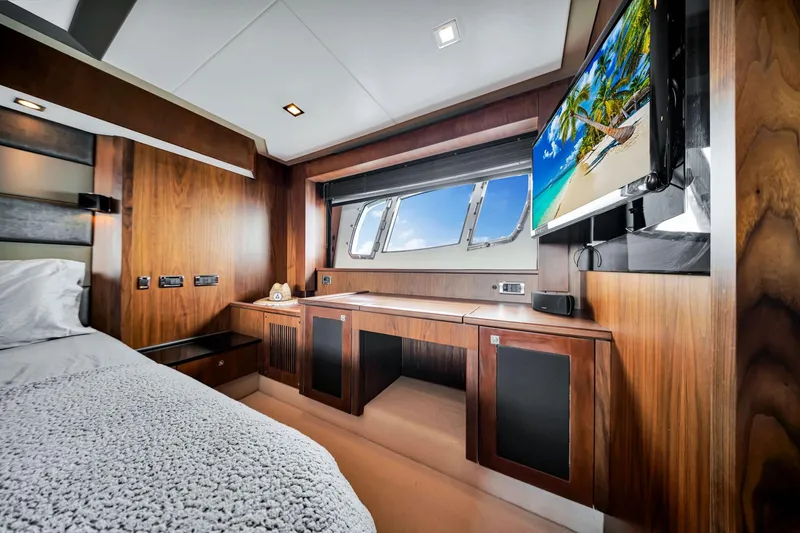 Jimbo Yacht Photos Pics Luxurious cabin interior of 2012 Sunseeker 74 Sport Yacht with wood finish and ocean view.