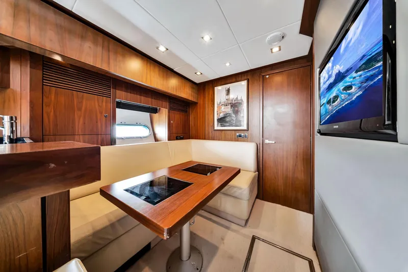 Jimbo Yacht Photos Pics Luxurious interior of 2012 Sunseeker 74 Sport Yacht with wood paneling and modern amenities.