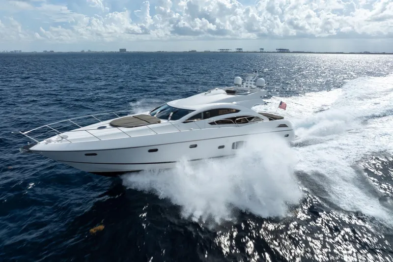 Jimbo Yacht Photos Pics Sunseeker 74 Sport Yacht 2012 cruising on open sea under a cloudy sky.
