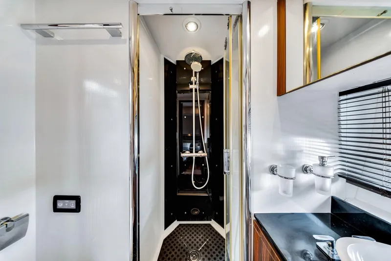 Jimbo Yacht Photos Pics Luxurious bathroom interior of 2012 Sunseeker 74 Sport Yacht with modern shower and sleek design.