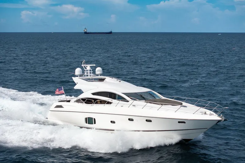 Jimbo Yacht Photos Pics Sunseeker 74 Sport Yacht 2012 cruising on open sea with American flag.