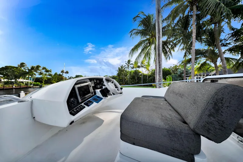 Jimbo Yacht Photos Pics Helm of 2012 Sunseeker 74 Sport Yacht with palm trees and blue sky backdrop.