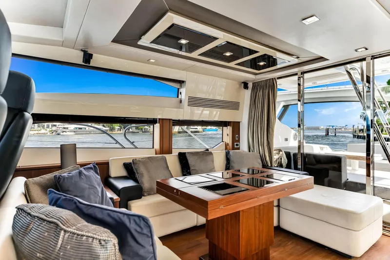 Jimbo Yacht Photos Pics Luxurious interior of 2012 Sunseeker 74 Sport Yacht with elegant seating and waterfront view.
