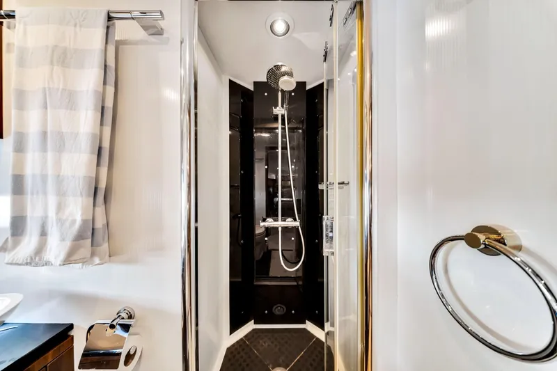 Jimbo Yacht Photos Pics Luxurious shower in 2012 Sunseeker 74 Sport Yacht bathroom, featuring modern fixtures and elegant design.