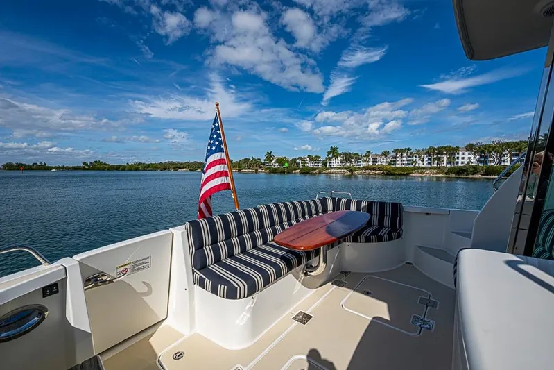  Yacht Photos Pics 2016 Sabre 42 Salon Express yacht with striped seating and American flag on a sunny day.