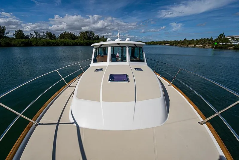  Yacht Photos Pics 2016 Sabre 42 Salon Express yacht on serene waterway under blue sky.