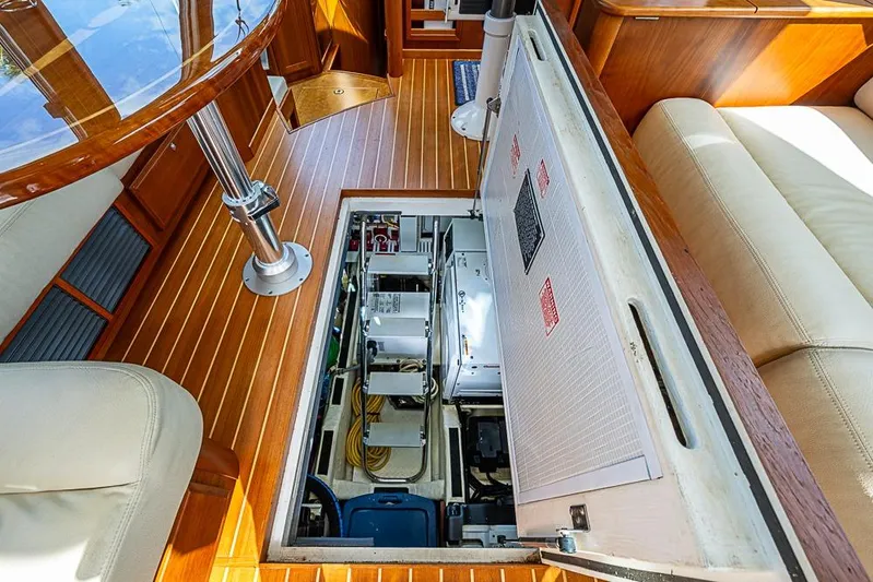  Yacht Photos Pics Engine compartment of 2016 Sabre 42 Salon Express yacht, featuring wooden interior and seating.