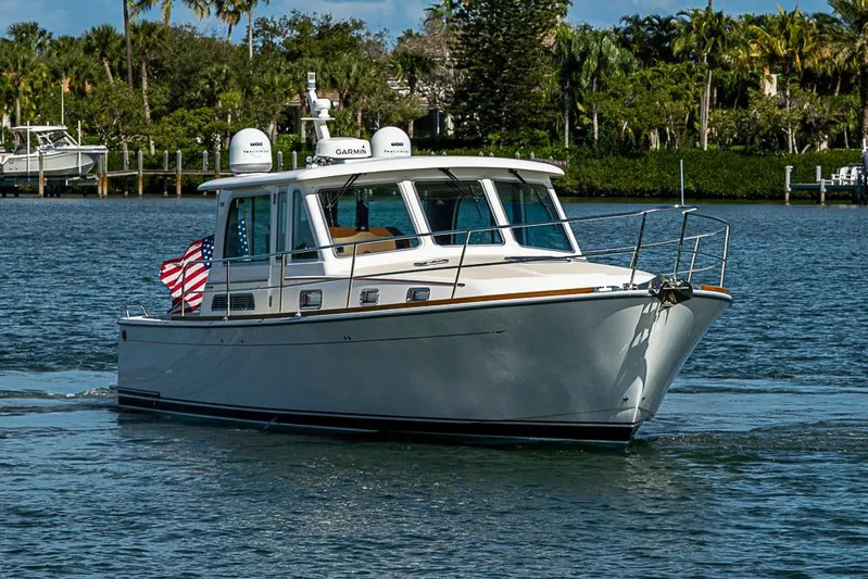  Yacht Photos Pics 2016 Sabre 42 Salon Express cruising on a scenic waterway with lush greenery.