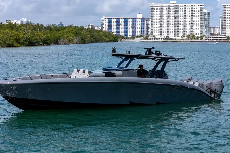  Yacht Photos Pics 2023 Midnight Express 43 Solstice boat on water with cityscape background.