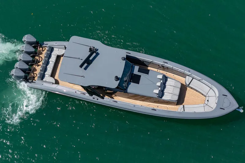  Yacht Photos Pics 2023 Midnight Express 43 Solstice luxury boat cruising on clear blue water.