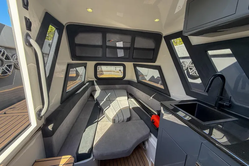  Yacht Photos Pics Luxurious interior of 2023 Midnight Express 43 Solstice boat with seating and kitchenette.
