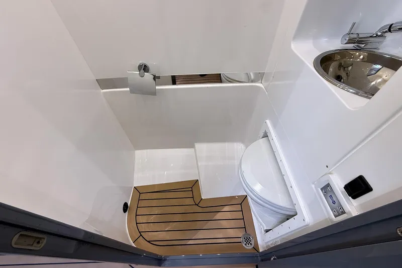  Yacht Photos Pics 2023 Midnight Express 43 Solstice boat bathroom with modern fixtures and wooden flooring.