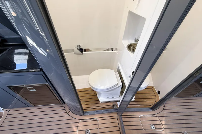  Yacht Photos Pics 2023 Midnight Express 43 Solstice yacht bathroom with modern fixtures and wooden flooring.