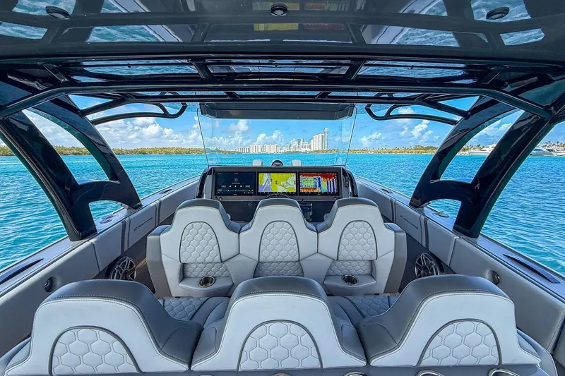  Yacht Photos Pics Interior view of 2023 Midnight Express 43 Solstice boat with luxurious seating and navigation screens.