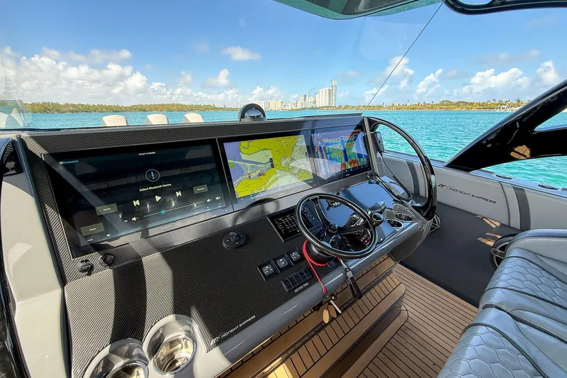  Yacht Photos Pics 2023 Midnight Express 43 Solstice helm with advanced navigation screens and luxurious seating.