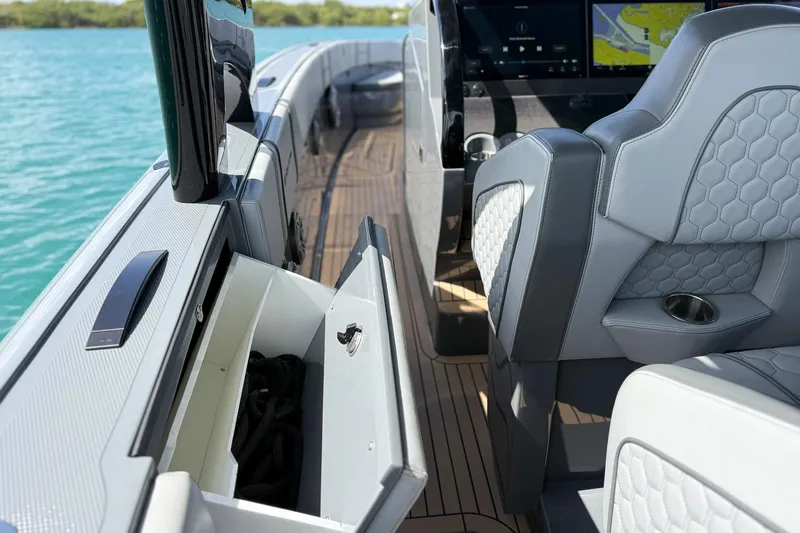  Yacht Photos Pics 2023 Midnight Express 43 Solstice boat interior with luxury seating and storage compartment.