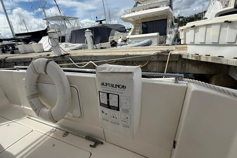  Yacht Photos Pics 2004 Meridian 459 Motoryacht docked, featuring lifesaving equipment and a lifebuoy on deck.