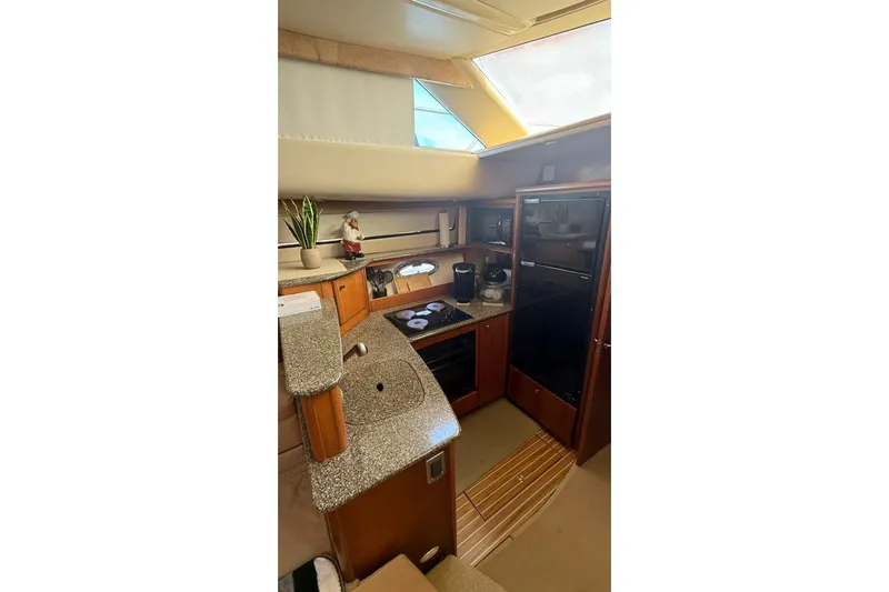  Yacht Photos Pics 2004 Meridian 459 Motoryacht kitchen with granite countertops and modern appliances.