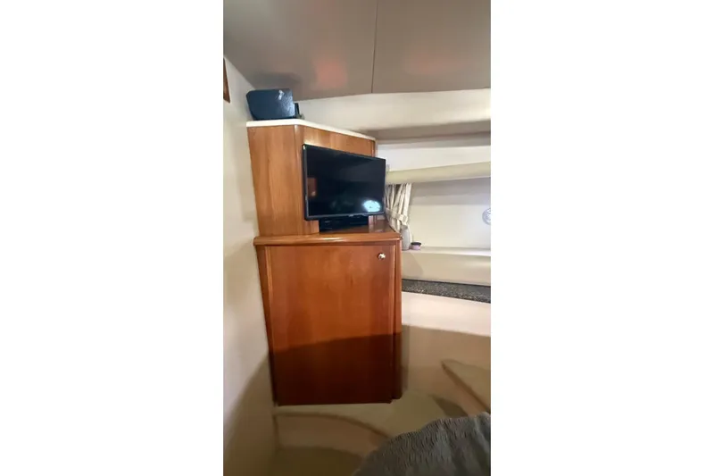  Yacht Photos Pics Interior of 2004 Meridian 459 Motoryacht with TV and wooden cabinet.