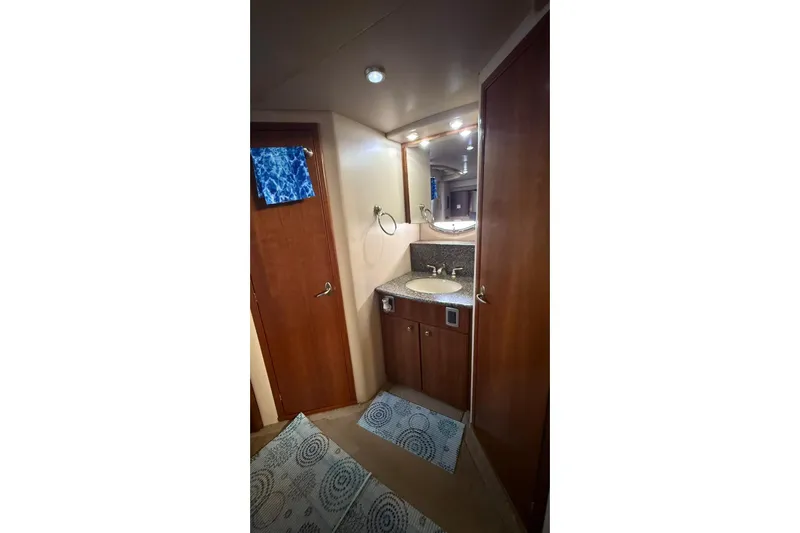  Yacht Photos Pics Bathroom interior of 2004 Meridian 459 Motoryacht with wooden cabinetry and sink.