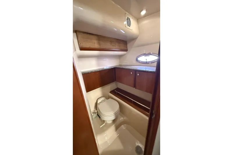  Yacht Photos Pics Luxurious bathroom in 2004 Meridian 459 Motoryacht with wood cabinetry and porthole window.