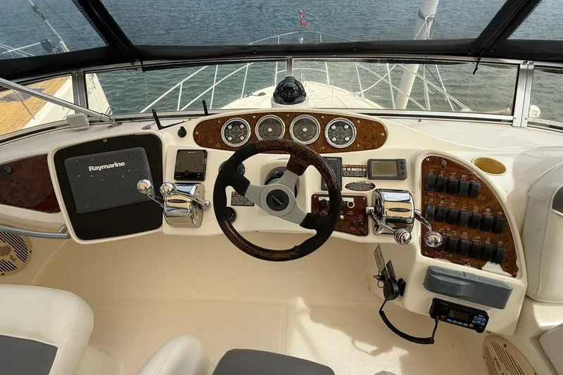  Yacht Photos Pics 2004 Meridian 459 Motoryacht helm with Raymarine navigation, steering wheel, and control panel.