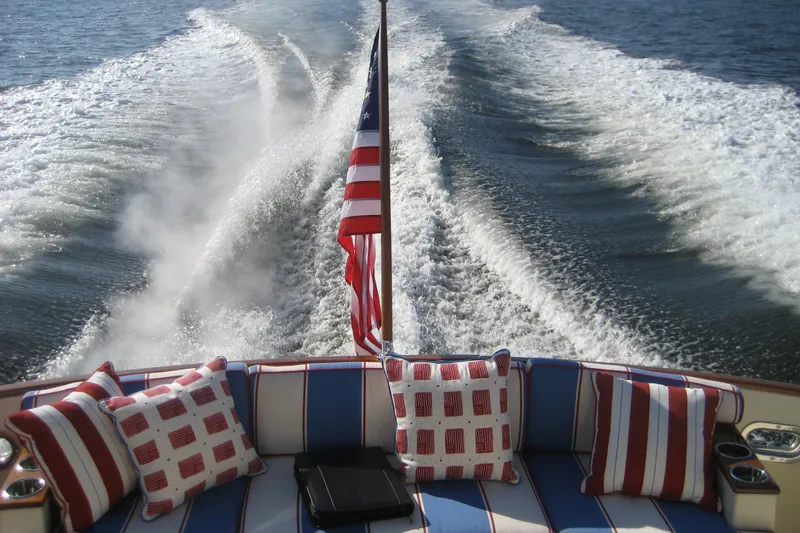 Off Islander Yacht Photos Pics Rear view of 2007 Legacy Yachts 32, featuring wake and patriotic-themed cushions.