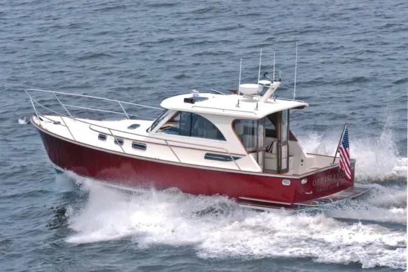 Off Islander Yacht Photos Pics 2007 Legacy Yachts 32 cruising on open water, displaying American flag.