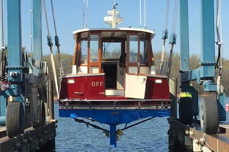 Off Islander Yacht Photos Pics 2007 Legacy Yachts 32 being lifted from water by boat hoist.