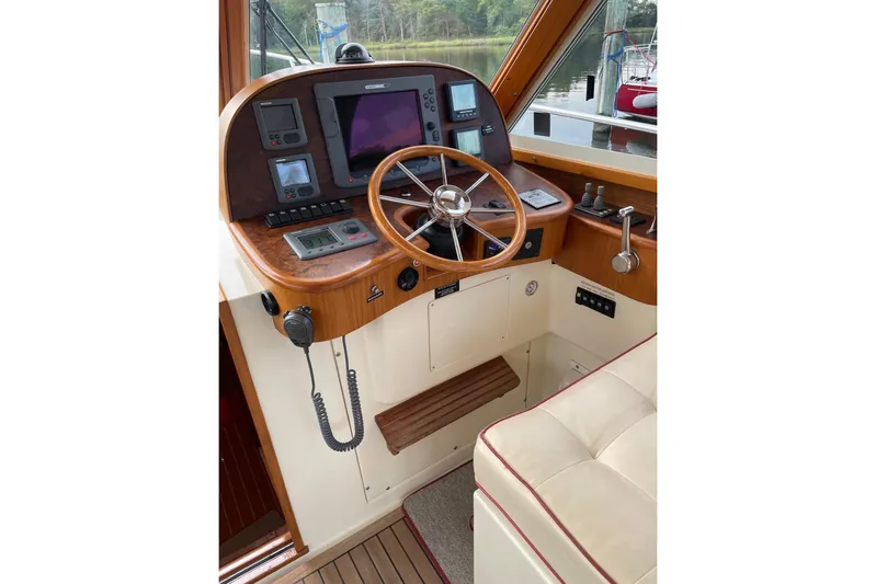Off Islander Yacht Photos Pics 2007 Legacy Yachts 32 helm with wooden steering wheel and navigation instruments.